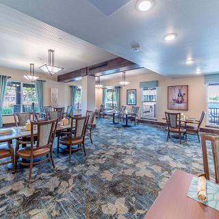 Spacious dining area with elegant furniture and natural lighting.