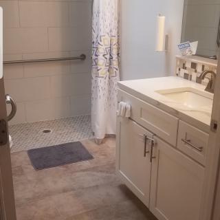 A clean and modern bathroom with a shower and sink.