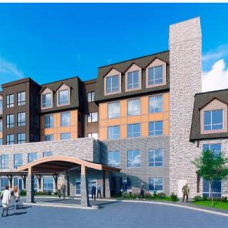 Modern hotel building with an inviting entrance and people gathered outside.
