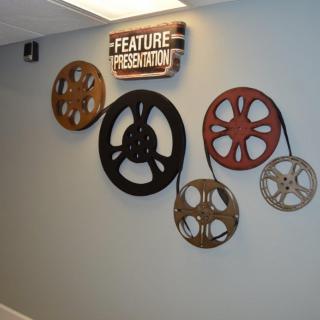 Wall decor featuring vintage film reels and a 'Feature Presentation' sign.