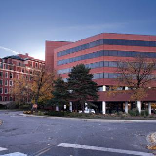 A modern commercial building surrounded by greenery, showcasing contemporary architecture.