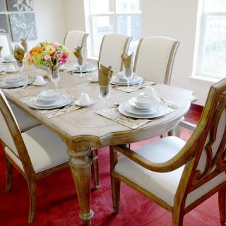 Elegant dining room with a set table and floral centerpiece.