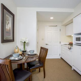 A cozy apartment kitchen with a small dining table set for two.