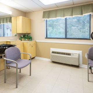 A clean and modern waiting room with simple furniture and natural light.