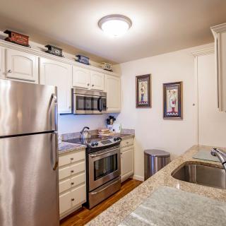 A modern kitchen with stainless steel appliances and a granite countertop.