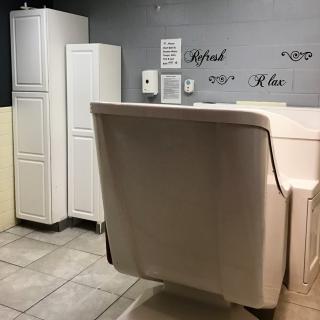 Stylish salon interior with a comfortable chair and sleek storage cabinets.