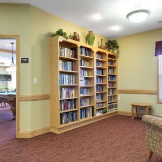 A cozy reading room with bookshelves filled with books.