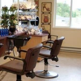Interior of a hair salon with styling chairs and products on display.