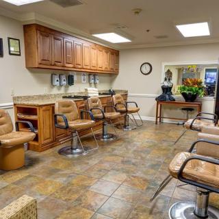 Interior view of a hair salon with chairs and mirrors.