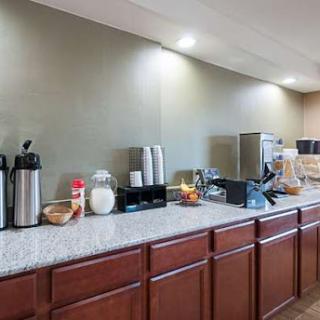 A modern kitchen countertop featuring various appliances and storage containers.