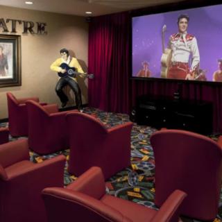 A cozy home theater with retro decor and comfortable seating, showcasing a vintage movie on the big screen.