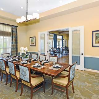 Elegantly designed dining room with a set table and chandelier.
