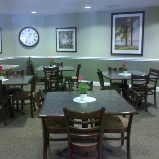 A quiet restaurant dining area with tables and chairs neatly arranged.