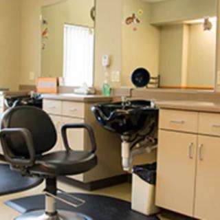 A well-equipped barbershop with chairs, mirrors, and sinks ready for use.