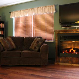 A cozy living room featuring a comfortable sofa, a warm fireplace, and a television, creating an inviting atmosphere.
