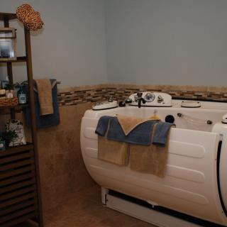 A cozy bathroom with a modern bathtub and neatly arranged towels.