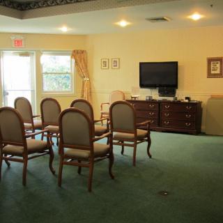 A cozy living area with chairs arranged facing a television.