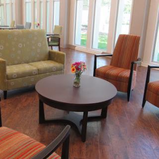 A cozy seating area featuring a round coffee table and modern chairs.