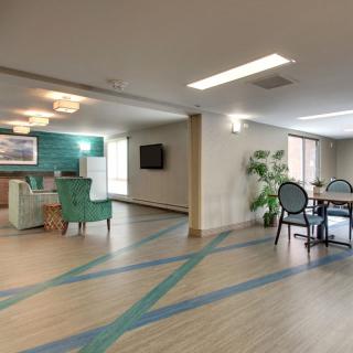 A modern and spacious living area with comfortable seating, a TV, and decorative elements.