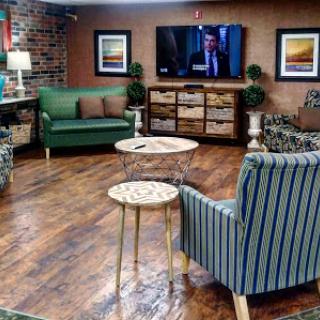 A cozy lounge area featuring modern furniture, a television, and stylish decor.