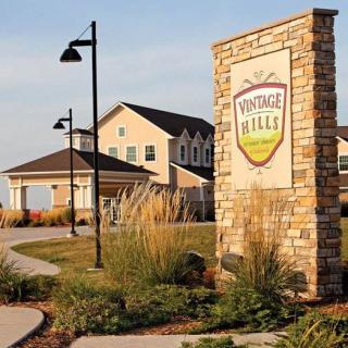 Entrance to a residential housing complex with landscaped pathways.
