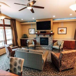 Cozy living room with a fireplace and comfortable seating arrangement.