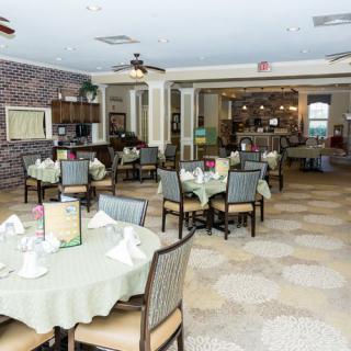 An elegantly decorated dining room with neatly arranged tables and chairs.