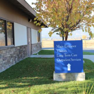 A sign indicating the location of health and long-term care services at a facility.
