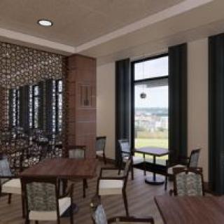 A modern restaurant dining area with stylish furniture and large windows.