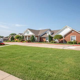 A suburban neighborhood with brick houses and well-maintained lawns.