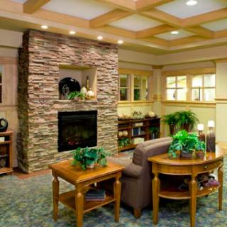 A cozy living room featuring a stone fireplace and inviting furniture.