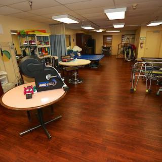 A rehabilitation room equipped with various therapy tools and equipment.