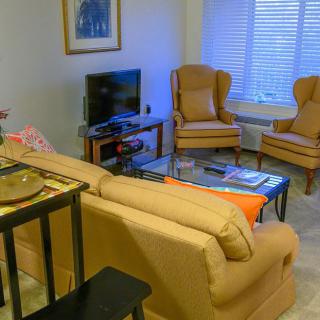 A cozy living room with comfortable seating and a television.
