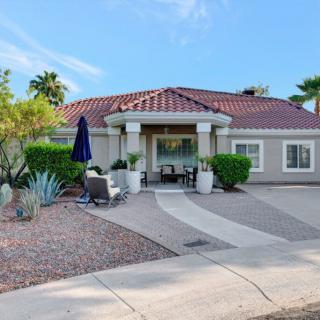 A beautiful single-story house with a landscaped front yard and a driveway.