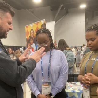 A group of people engaged in a conversation at a conference.