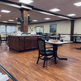 A spacious dining area featuring elegant wooden furniture and ample natural light.
