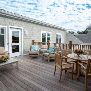 A cozy outdoor patio with wooden furniture and a scenic view.