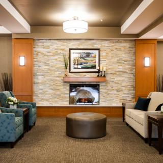 A modern lobby with comfortable seating and a cozy fireplace.