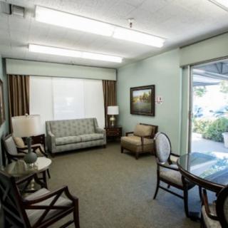 A cozy waiting room with comfortable seating and warm lighting.