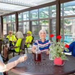 A group of people enjoying a relaxed social gathering on an outdoor patio.