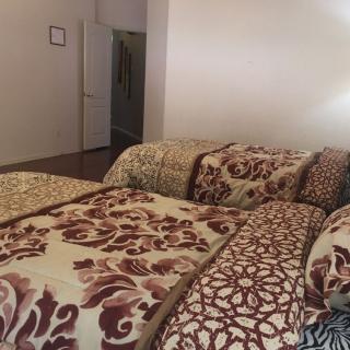 A cozy bedroom with patterned bedding and pillows.