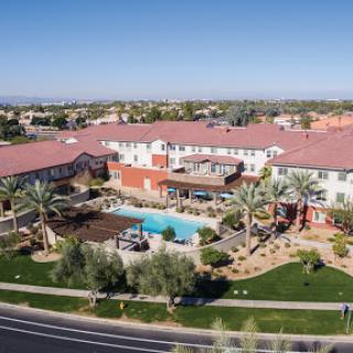 Aerial view of a beautiful resort featuring a pool and lush landscaping.