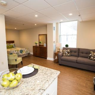 A modern and cozy apartment interior featuring a well-lit living area with stylish furniture.