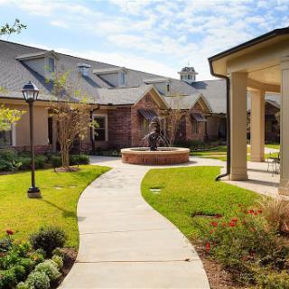 A serene courtyard with pathways and well-maintained gardens.