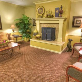 A cozy living room featuring a fireplace, comfortable seating, and warm decor.