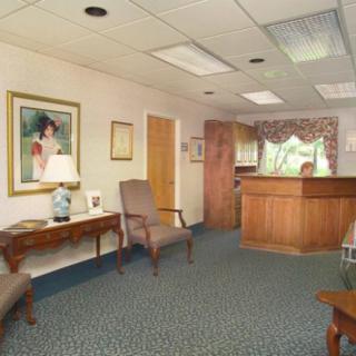 A cozy waiting room with comfortable seating and decorative artwork.