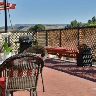 A cozy patio with outdoor seating and a scenic view.