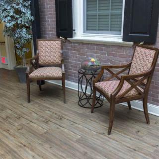 A cozy patio setup with two chairs and a small table.
