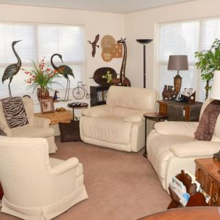 A cozy living room with plush chairs, elegant decor, and soft neutral tones.