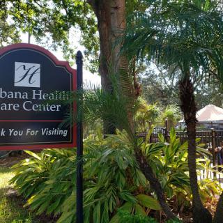 A welcoming sign for the Habana Healthcare Center, surrounded by lush greenery.